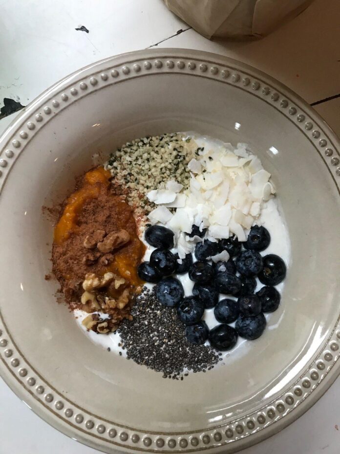 A mixing bowl filled with enticing ingredients like almond flour, cinnamon, and coconut oil, ready to be transformed into healthy Snickerdoodle Fat Balls.