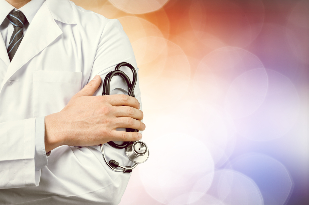 Doctor holding stethoscope with colorful background.