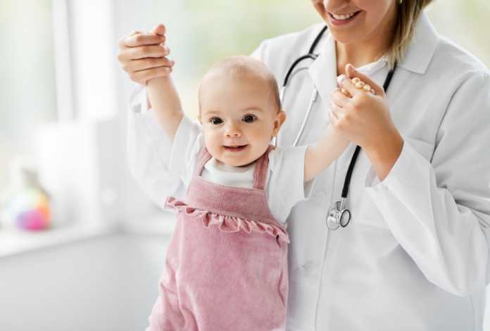 a picture of a doctor holding an infant