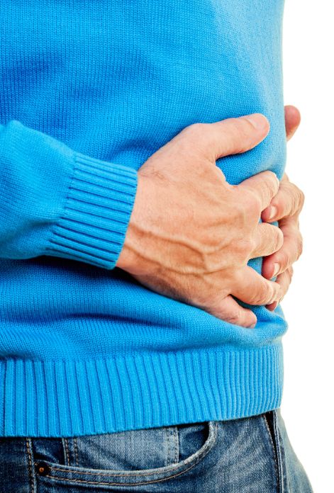 Man with stomachache keeps hands in his belly