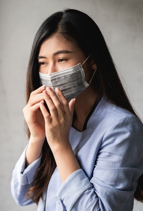 Woman with mask feeling uncomfortable and sick