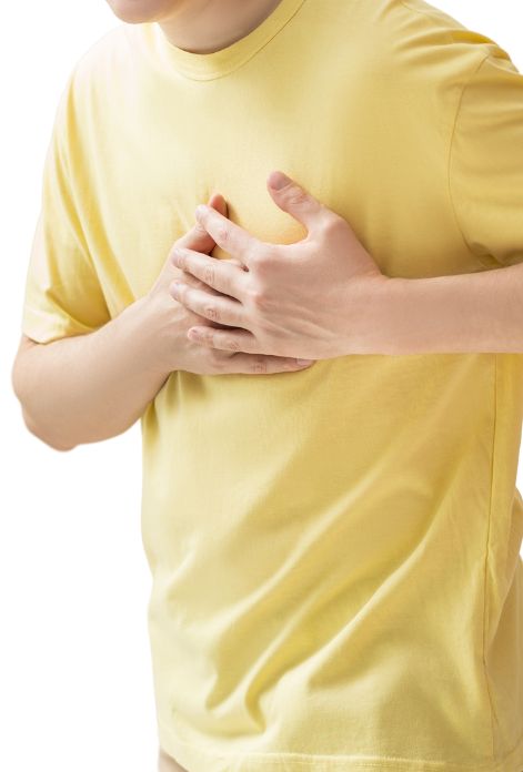 Man with hands on chest experiencing pain due to high cholesterol