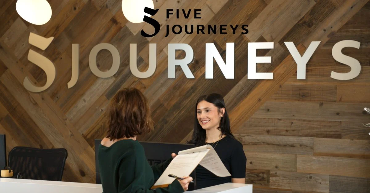 Vibrant and inviting Five Journeys Boston lobby with friendly receptionists welcoming patients.