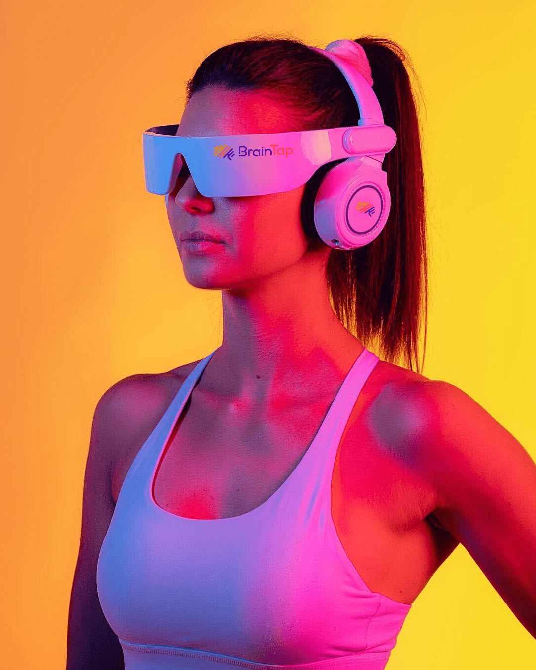 A woman receiving BrainTap therapy, appearing relaxed and focused.